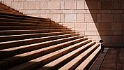 toddler standing in front of beige stair